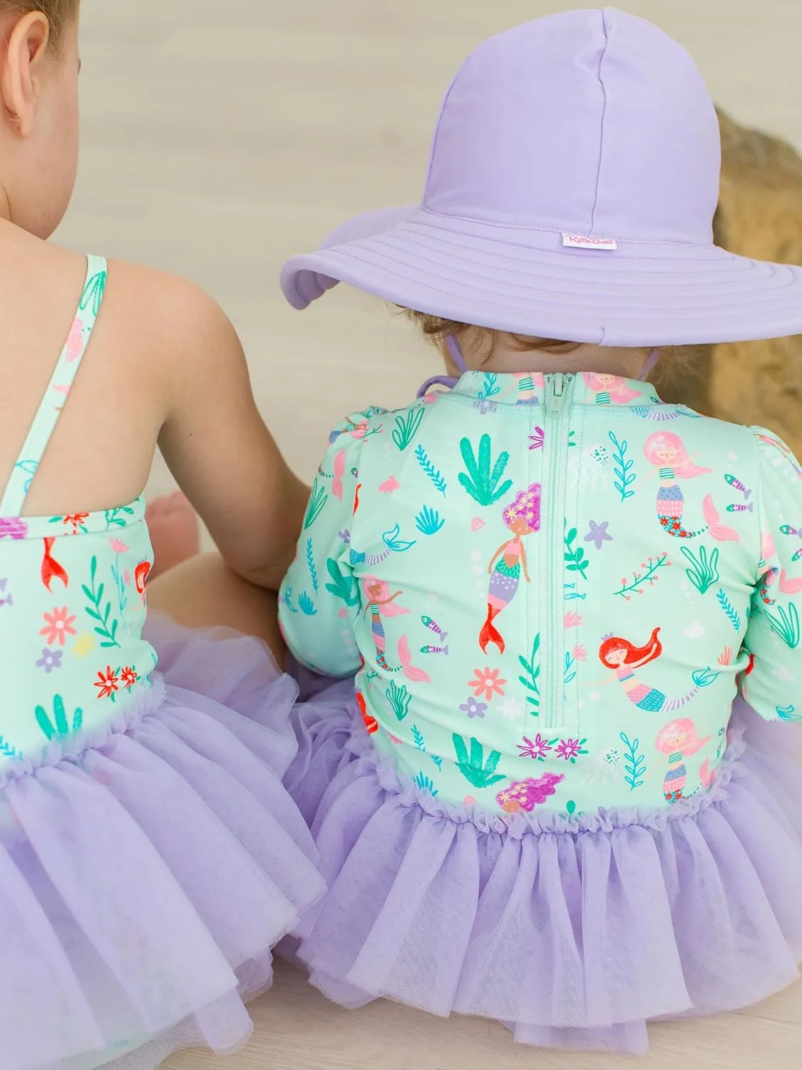 RuffleButts Baby Girls UPF 50  Sun Protection Tulle Skirted Long Sleeve One Piece Rash Guard Swimsuit